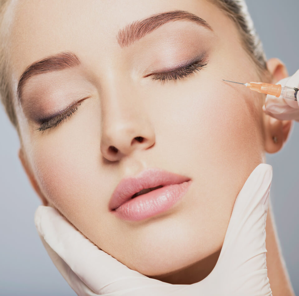 Stock image of face of girl been given a botox with injection on face