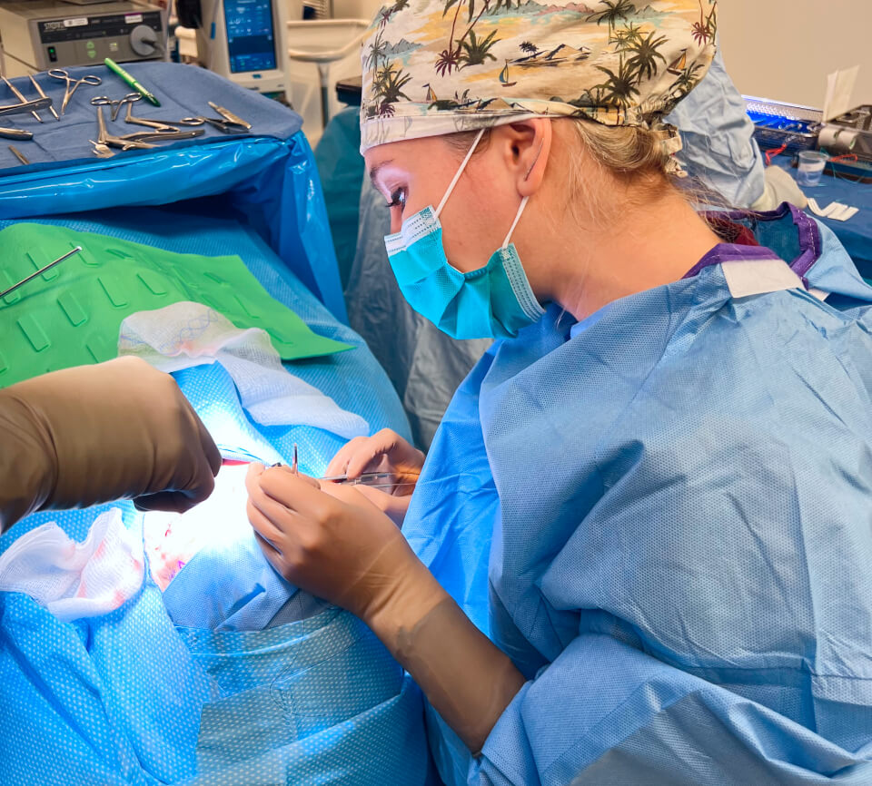 Picture of Jennifer Murdock MD working with a patient for upper eyelid surgery on bed along with some equipment closeup view