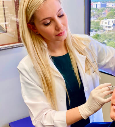 Picture of Jennifer Murdock MD working with a patient