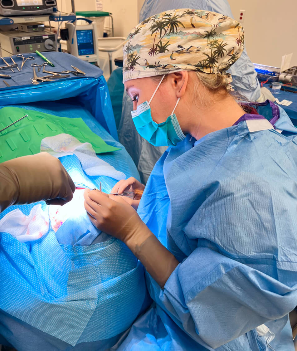 Picture of Jennifer Murdock MD working with a patient on bed along with some equipment closeup view