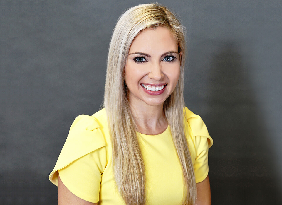 Smiling picture of Jennifer Murdock MD with yellow top