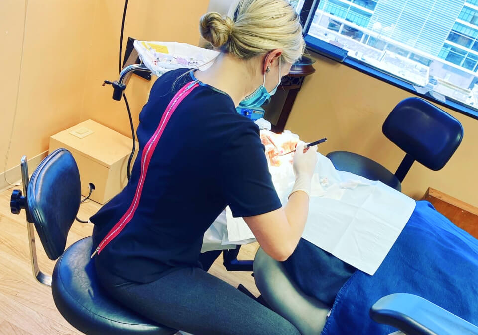 Picture of Jennifer Murdock MD working with a patient on bed along with some equipment