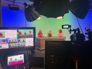 Dr Jennifer Murdock along with two others in a TV debate along with cameras lights