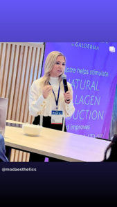 Dr Jennifer Murdock giving a speech by holding mic