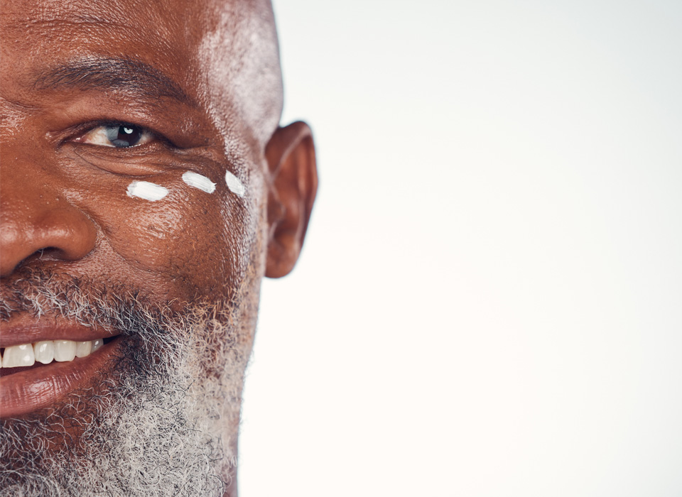 stock image of african model with three white dots on smiling face