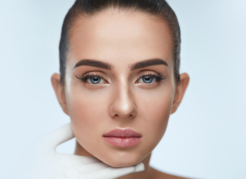 stock image of model face beauty and the soft, caring gesture of the gloves