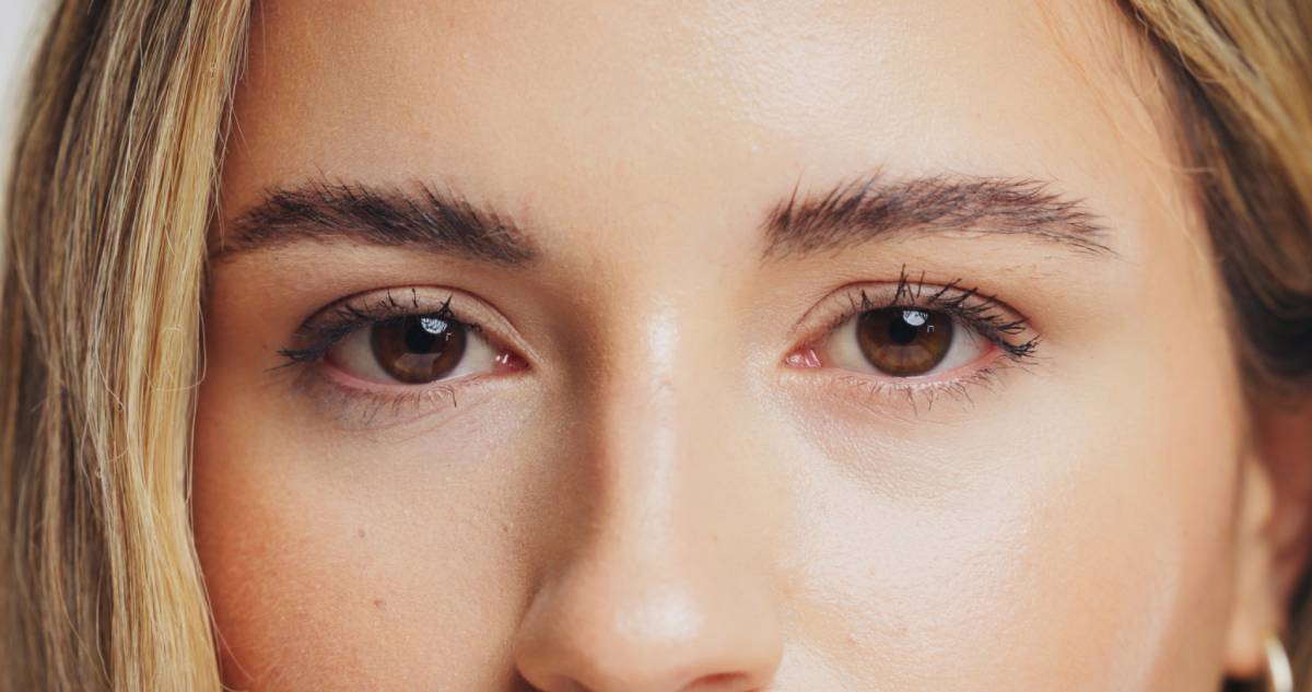 Portrait, woman and eyes with beauty in studio for skincare, laminated eyebrows and eyelash extension. Female person, cosmetics and lashes growth for transformation, treatment results and closeup